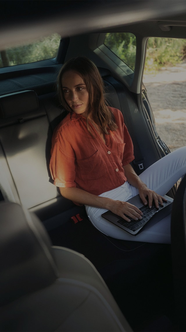 woman sitting inside seat ateca interior, black dark camouflage seating