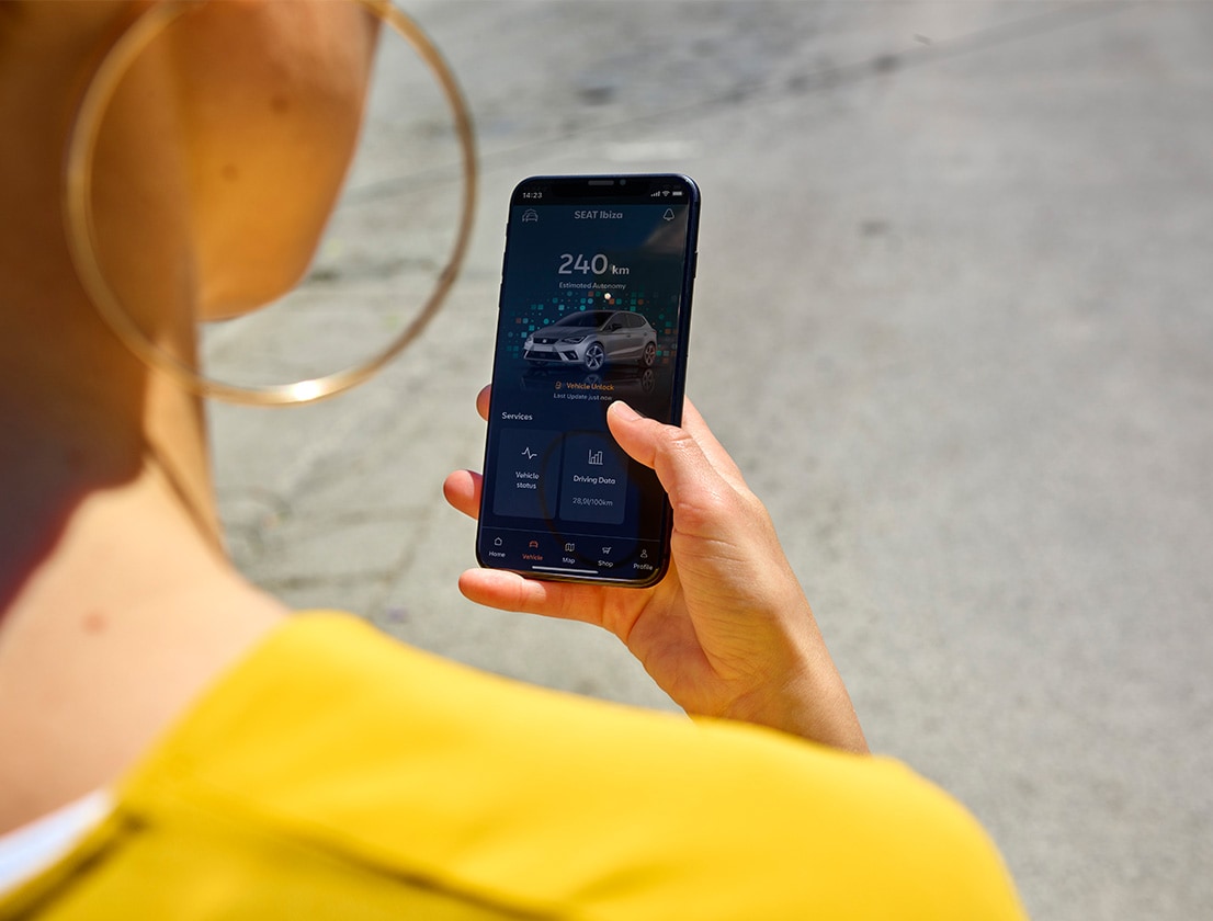 woman looking at her phone using seat connect